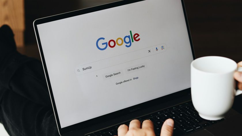 A person sitting in front of a laptop computer